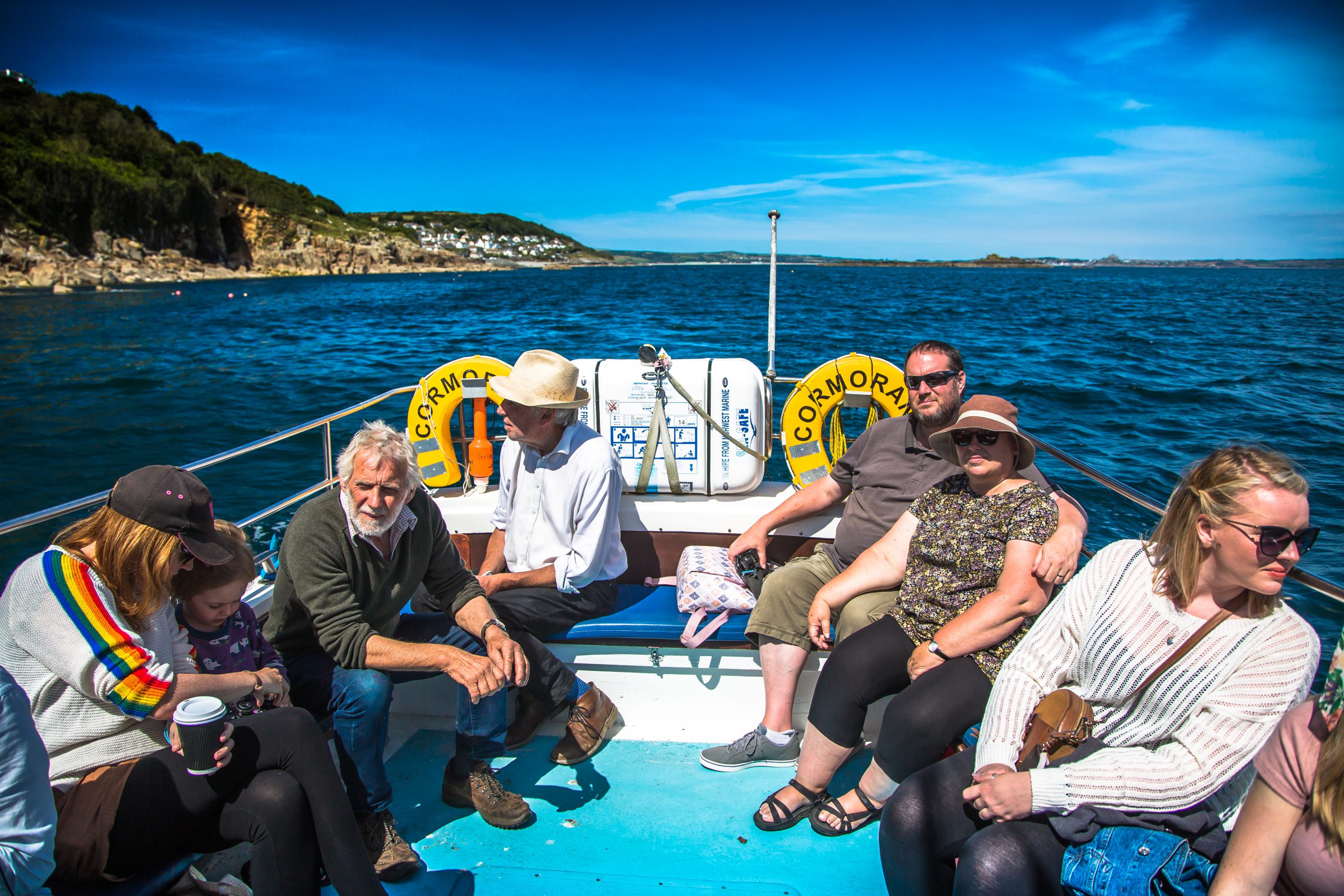 Passengers onboard the Cormorant enjoying the stunning Cornish coastline in the sunshine
