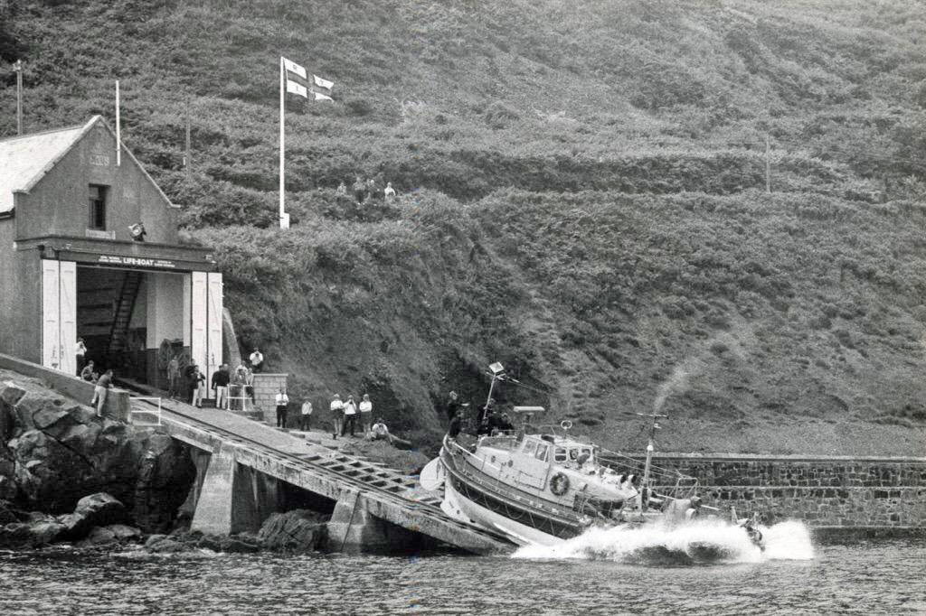 An old black and white picture showing the Penlee lifeboat being launched.